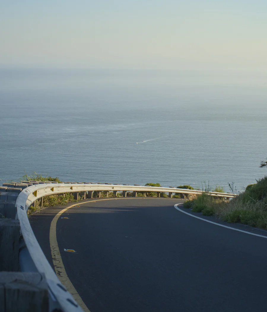A road curving along a clifftop above the sea